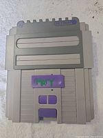 Top view showing dual cartridge slots, purple buttons and handwritten marking