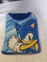 Folded Sonic pajama top with character graphic visible