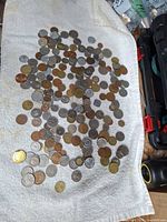 Overview of mixed world coins spread on towel