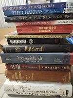 Stack of 11 occult and witchcraft books showing spines