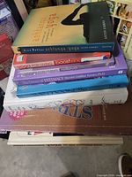 Stacked books showing spines and some titles