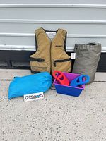 All items grouped: life jacket, boat cover sack, Pouch Couch bag, plastic tub, two carry handles