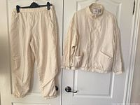 Full view of jacket and pants hanging