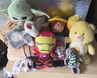 Group shot of all nine plush toys arranged on table