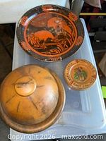 All three items grouped: metal wall plate, metal covered tray, ceramic ashtray