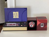 presentation box open showing ticket, pins, keychain, outer box for magnet puzzle ball