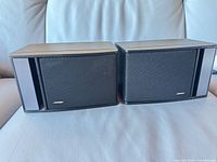 Front view of both Bose 141 Series II speakers with grilles and logos visible