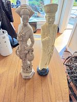 Front view of both resin figurines