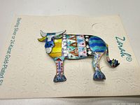 Front view of bull brooch on Zarah card showcasing full design and colors