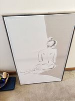 Front view of framed female nude line drawing print
