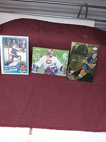 Front view of all three NHL hockey cards standing upright