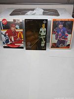 Front view of three hockey cards on display