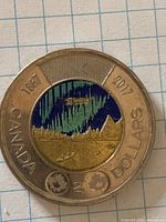 Reverse showing coloured aurora borealis design and dates 1867-2017