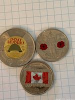 Group shot of three colourized Canadian coins showing obverse designs