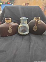Front view of three decorative vessels