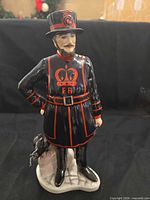 Front view of Coalport Beefeater figurine showing uniform details and stance