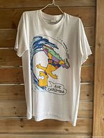 Full view of T-shirt front on hanger showing graphic and condition