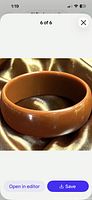 Angled view of entire bangle showing color, thickness and surface