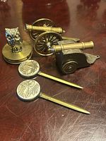 Group view of two cannons, owl magnifier and two letter openers