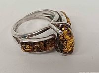 Side view showing sterling silver setting and amber cabochons