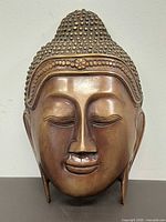 Front view of bronze Buddha head sculpture
