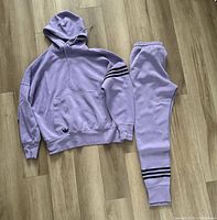 Full view of hoodie and joggers laid flat