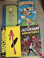 Front covers of all four comic books laid out on fabric surface