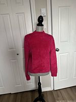 Front view of the fuchsia fuzzy sweater on mannequin