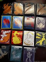 Fifteen sealed sleeve packs laid out showing assorted artwork