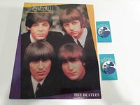 Front of puzzle box with Beatles portrait and two buttons