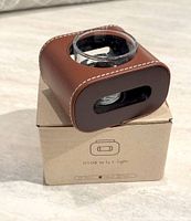 Holder on top of its labeled box showing design and materials