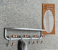Mirror and shelf shown mounted on wall for scale and relation