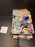 Stack topped by Robotech The New Generation #7