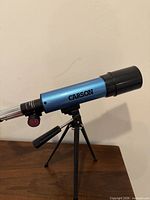 Left side view of Carson blue refractor telescope on tripod