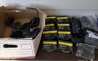 Cardboard box with accessories beside row of Forte boxed tubes