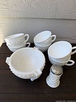 Group view of six cups, ashtray and shaker