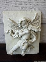 Front view of resin cherub wall plaque