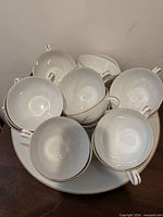 Stacked view of eight teacups arranged on platter