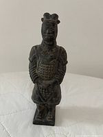Front view of charcoal-black terracotta warrior figurine