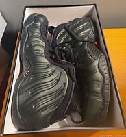 Pair of shoes in original box showing molded Foamposite uppers