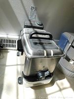 Front angle view of the stainless steel T Fal deep fryer featuring control dial and handle.