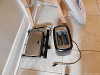 Side view of the Toastmaster toaster and the Casino Rama sandwich maker on the floor