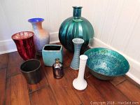 All eight items shown together on floor, including vases and decorative bowl.