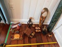 Overview photo showing all items together on wooden floor by white paneled wall.