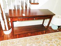 Full front view of wood side table with drawer and lower shelf