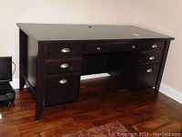 Front-left-facing view of the desk showing the three left drawers and part of the right side drawers.