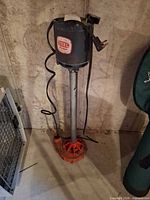 Full view of sump pump standing on basement floor