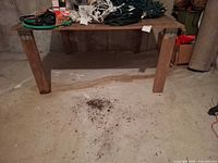 Full view of wood/composite workbench table in basement
