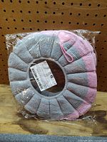 Two toilet seat covers in original plastic packaging