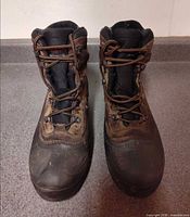 Front view of both boots showing laces, uppers, and toe condition